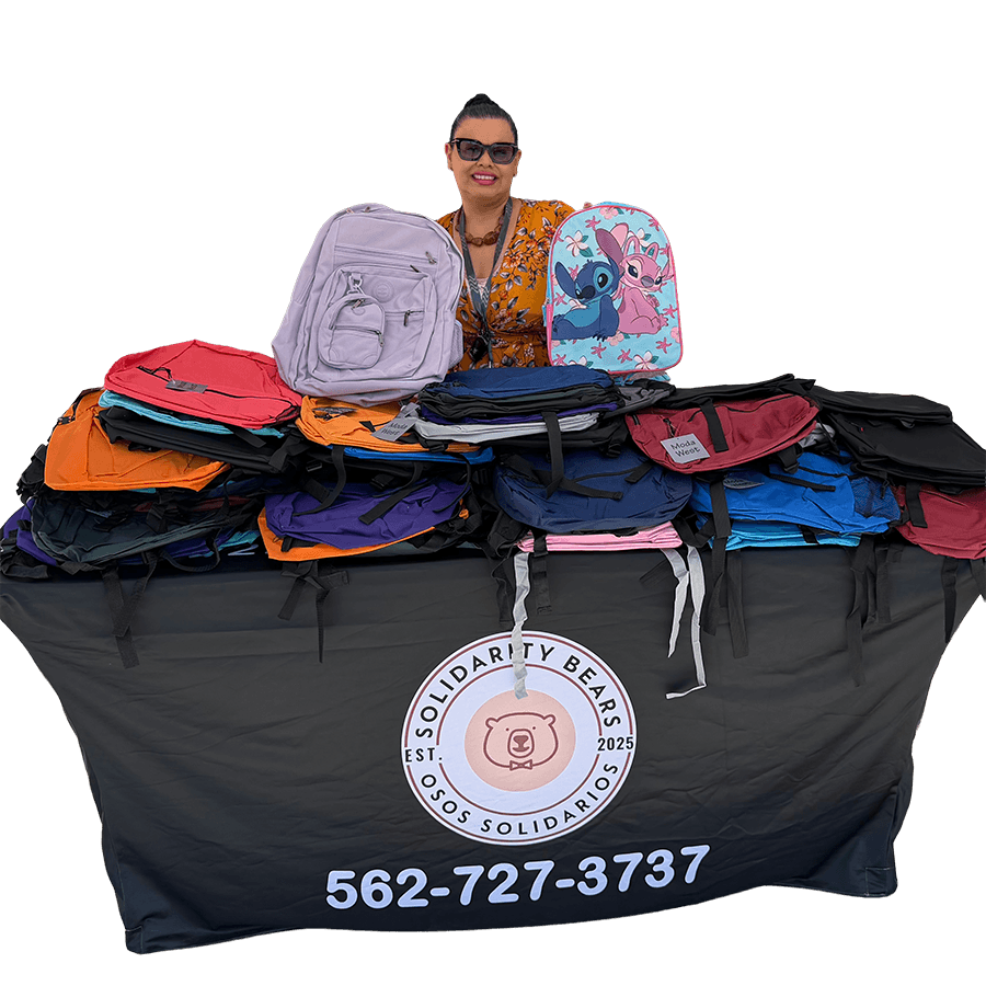 Lorena with donated backpacks at a Solidarity Bears community event